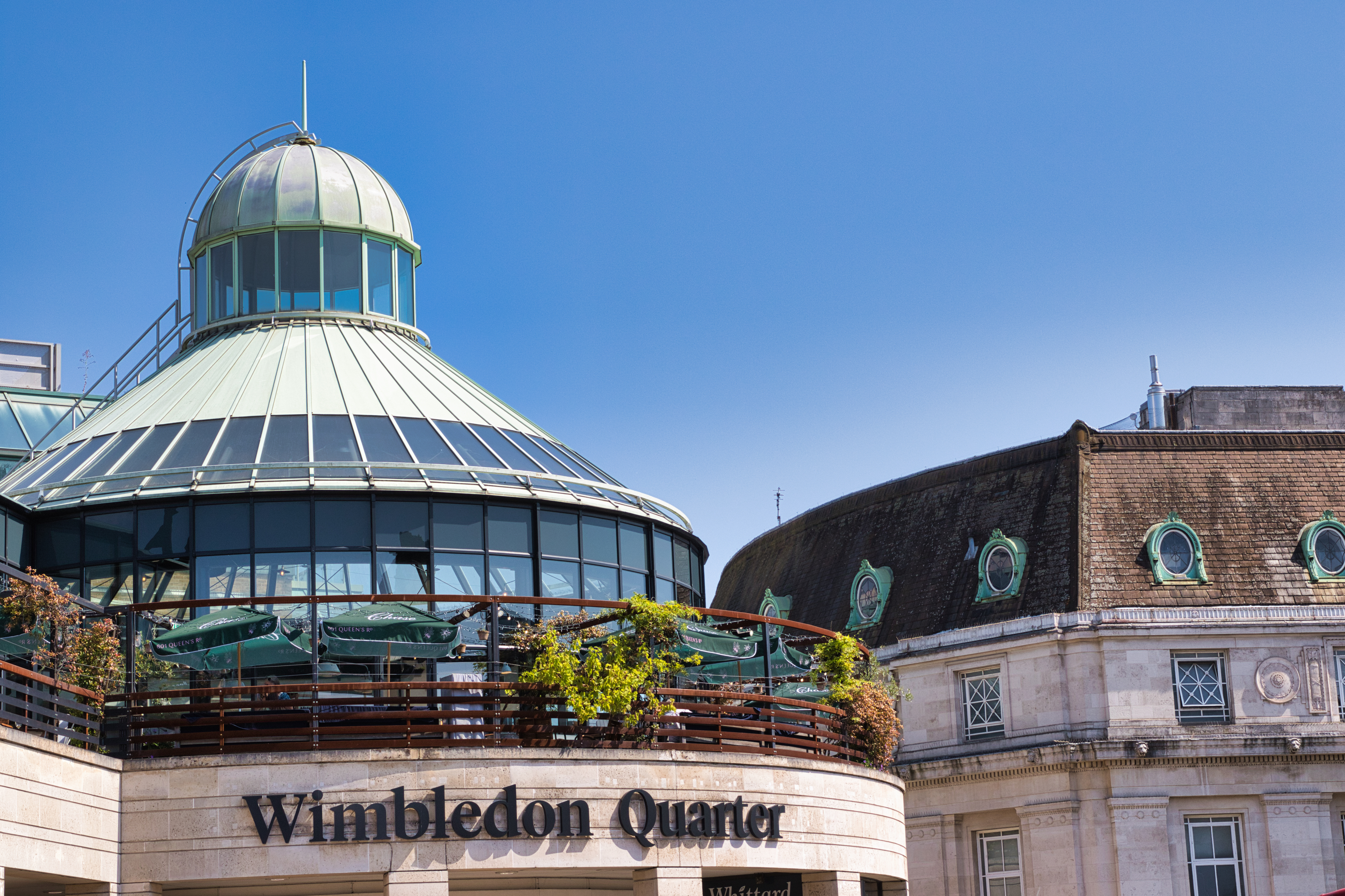 Wimbledon Quarter in the town centre under a clear blue sky, close to Wimbledon Station and the main shopping area.